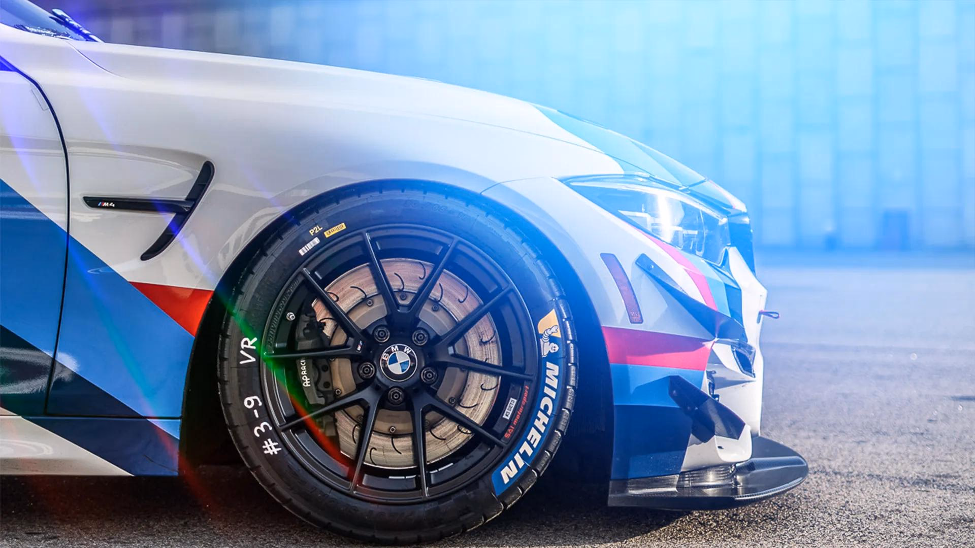 BMW M4 with colorful beauty overlay on front and wheel